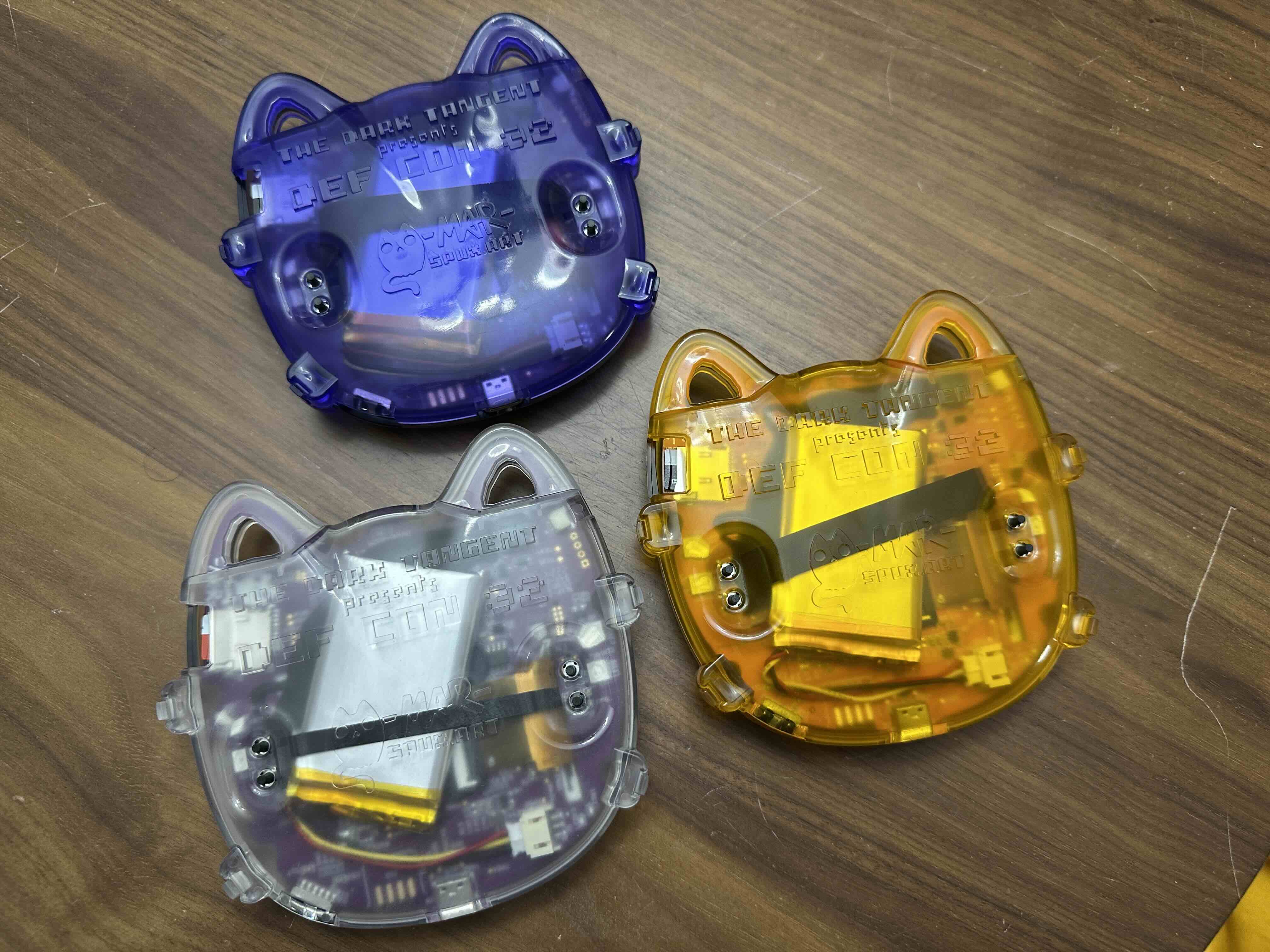 Yellow Contest badge, Purple Vendor badge, and Clear Human badges showing installed battery riser..