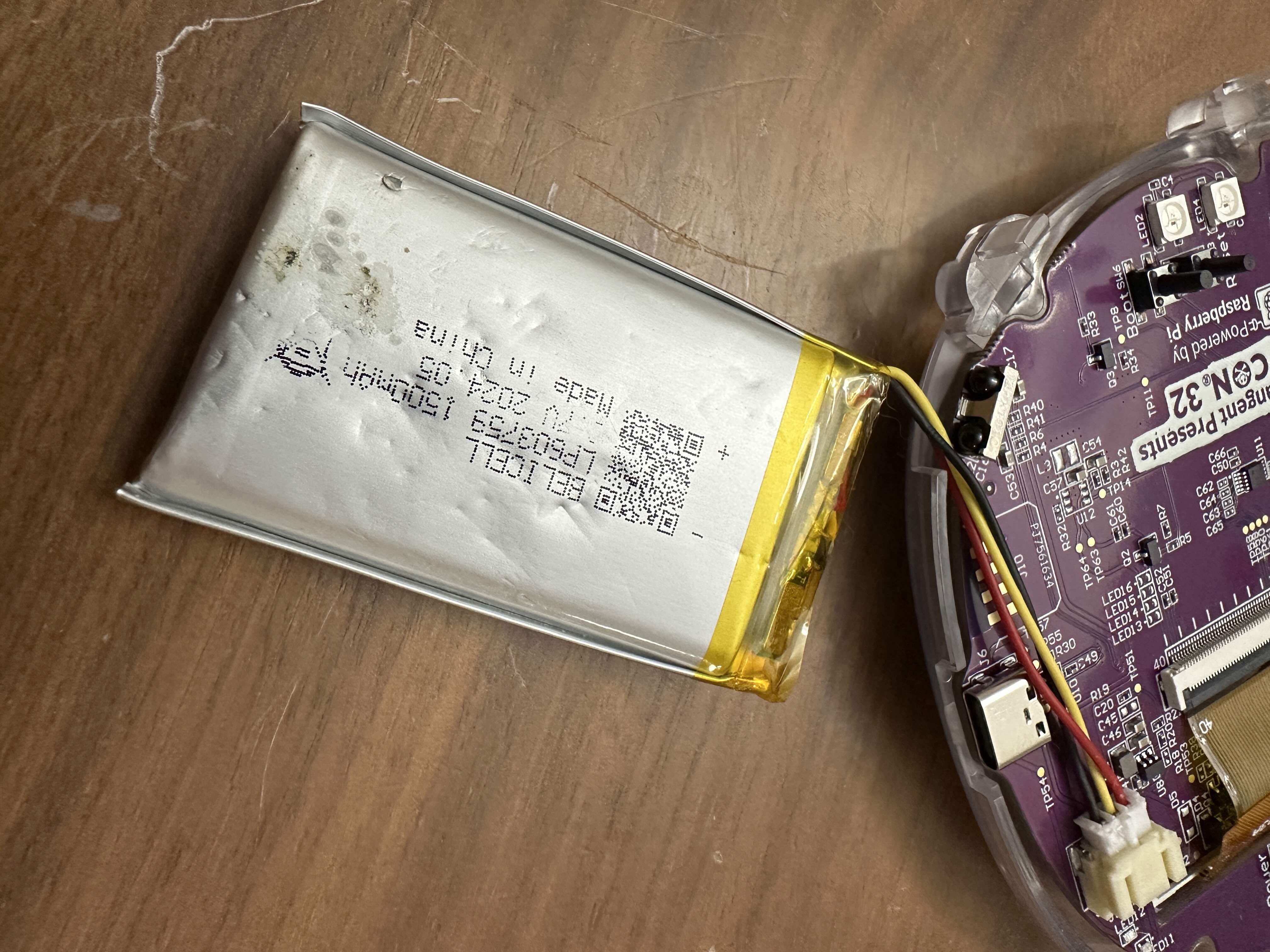 Underside of badge battery looking pretty beaten up, obvious indents where chips and surface mount components pressed against it.