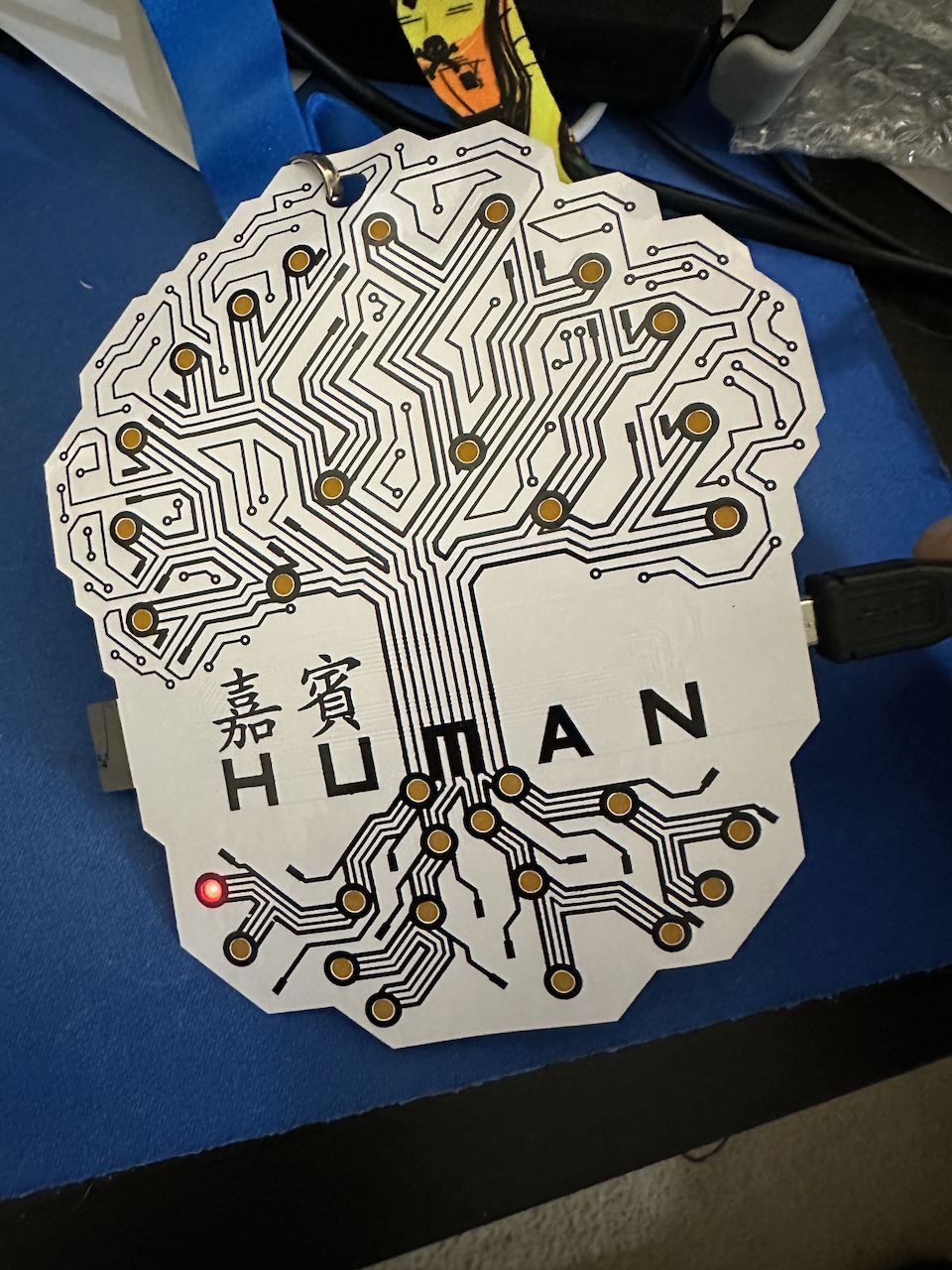 Badge showing a single LED lit, 15 to go...