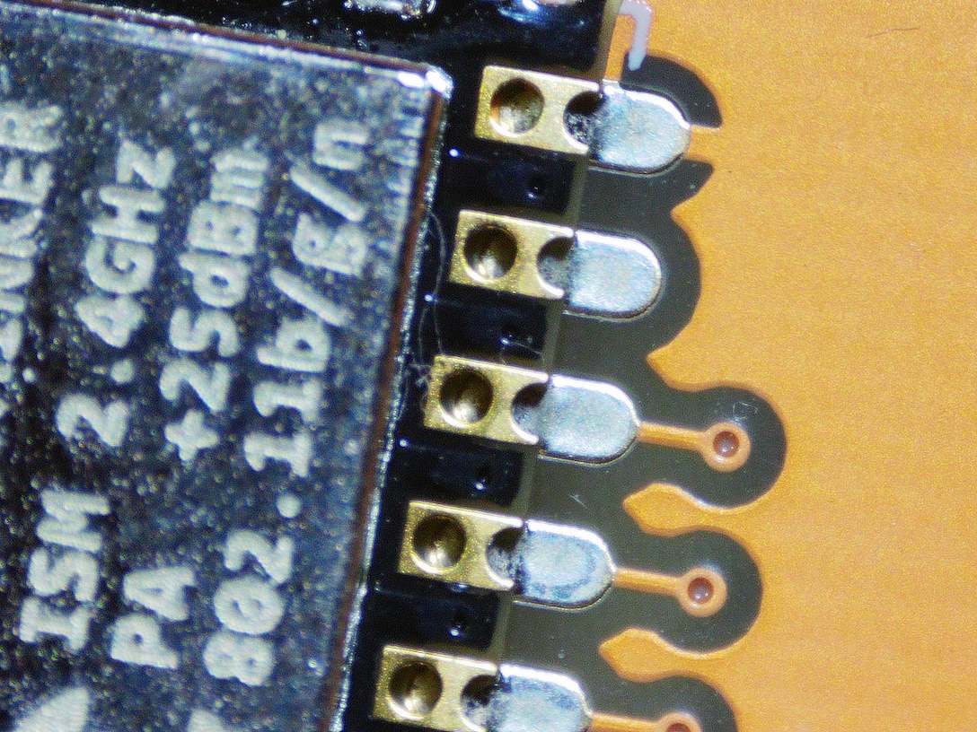 Another macro shot of MCU board very close where zero solder is seen connecting pins to PCB