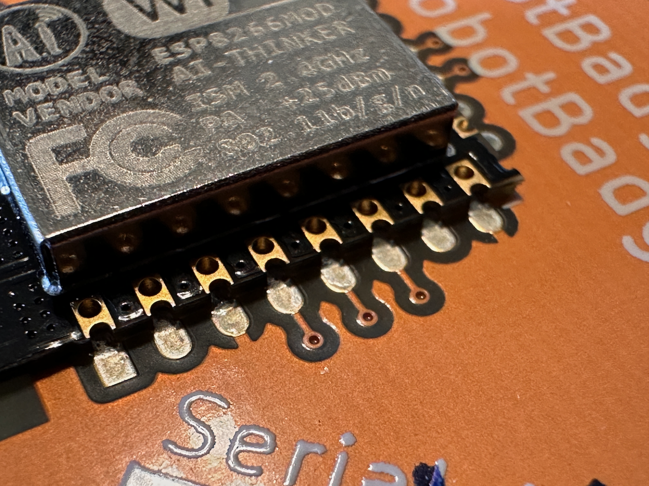 Macro shot of MCU board very close where zero solder is seen connecting pins to PCB